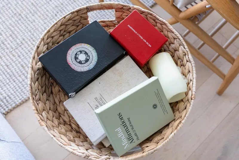 A basket of books and journals by the sofa