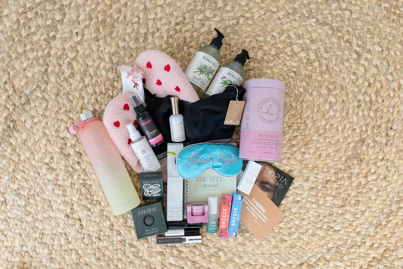 The gift bag’s goodies laid out on a woven mat