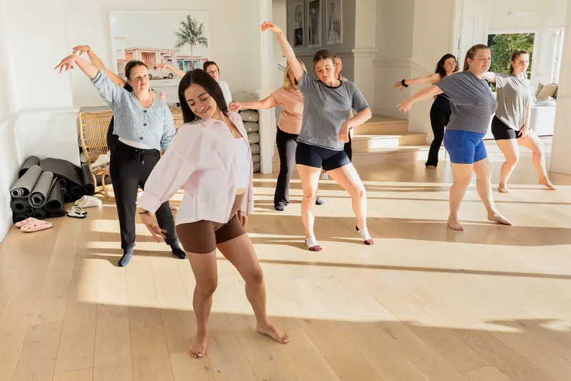 Guests dancing in the sunlit studio