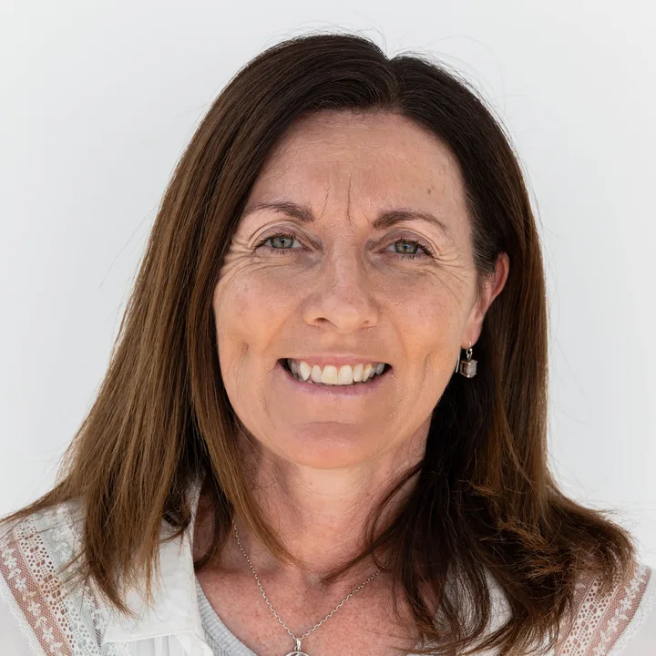 Angela D., smiling, in a white shirt