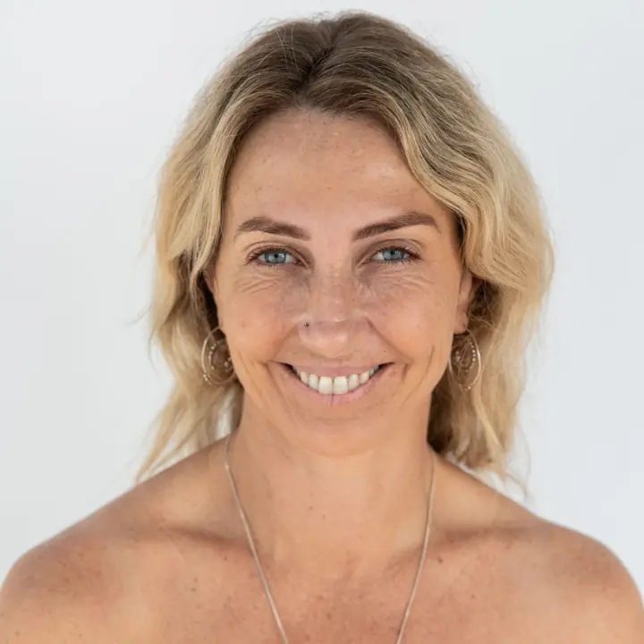 Nicole S., smiling, in a striped top