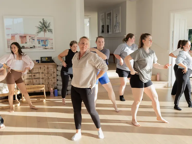 Guests mid-dance in the sunlit studio
